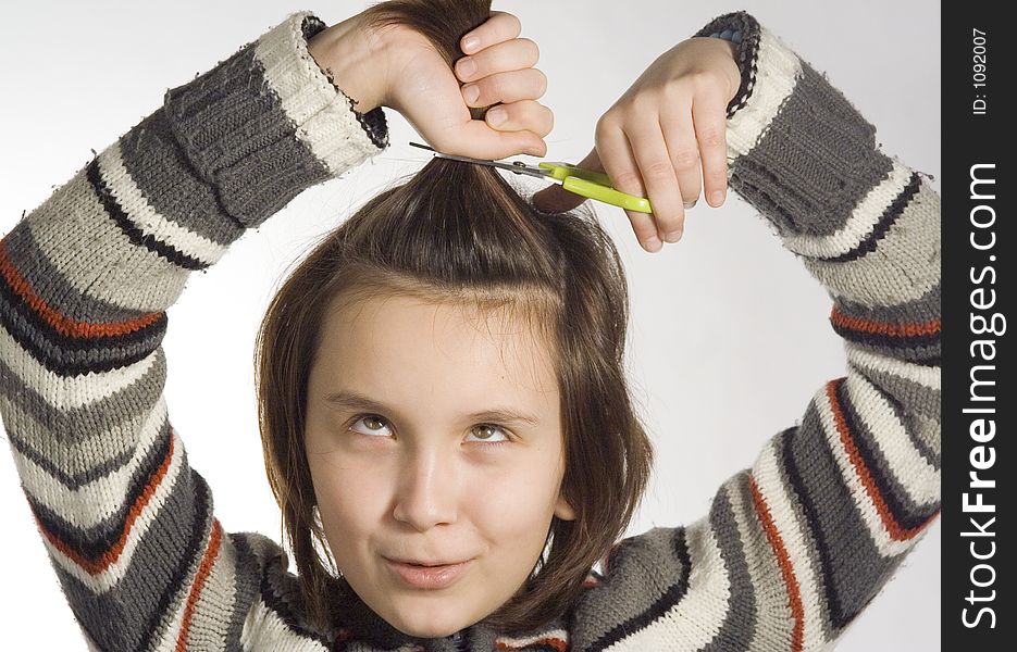 Girl cutting her hairs. Girl cutting her hairs