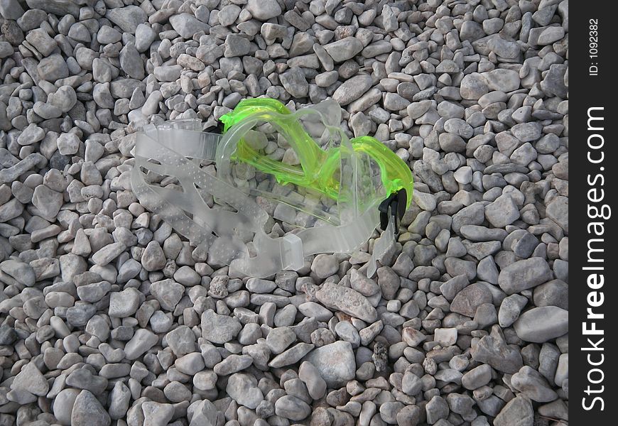 Diving mask on the pebble beach of Makarska, Croatia. Diving mask on the pebble beach of Makarska, Croatia.