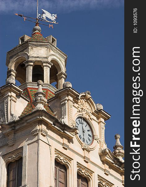 Town hall tower and clock against a blue sky. Town hall tower and clock against a blue sky