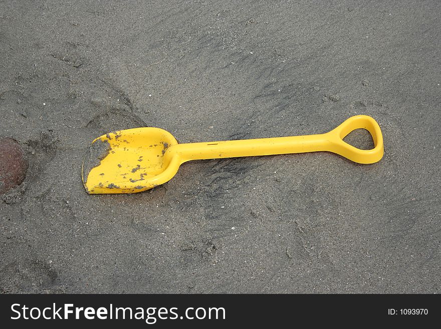 Plastic shovel on a beach