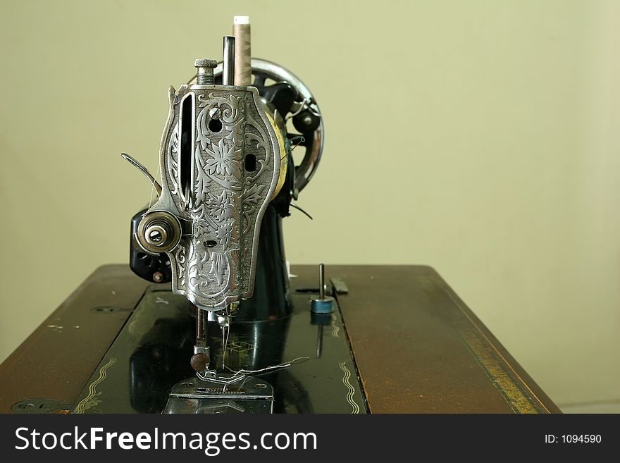 Vintage sewing machine with needle and thread