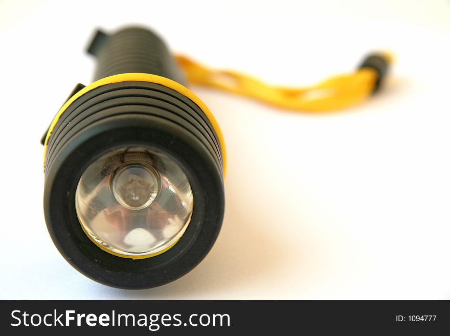 Black flaslight with yellow strap. Black flaslight with yellow strap