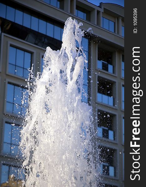 Fontana water drops  little blurred with modern building in background. Fontana water drops  little blurred with modern building in background