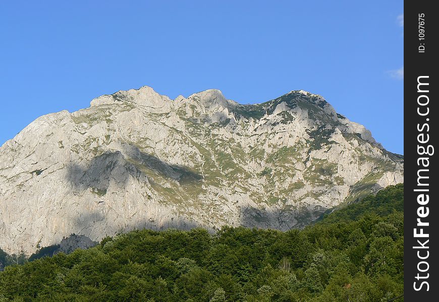 Mountain peak above dense forest in Bosnia. Mountain peak above dense forest in Bosnia