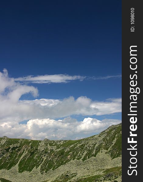 Peaks and beautiful dark blue sky with clouds on Retezat Mountains - Romania. Peaks and beautiful dark blue sky with clouds on Retezat Mountains - Romania