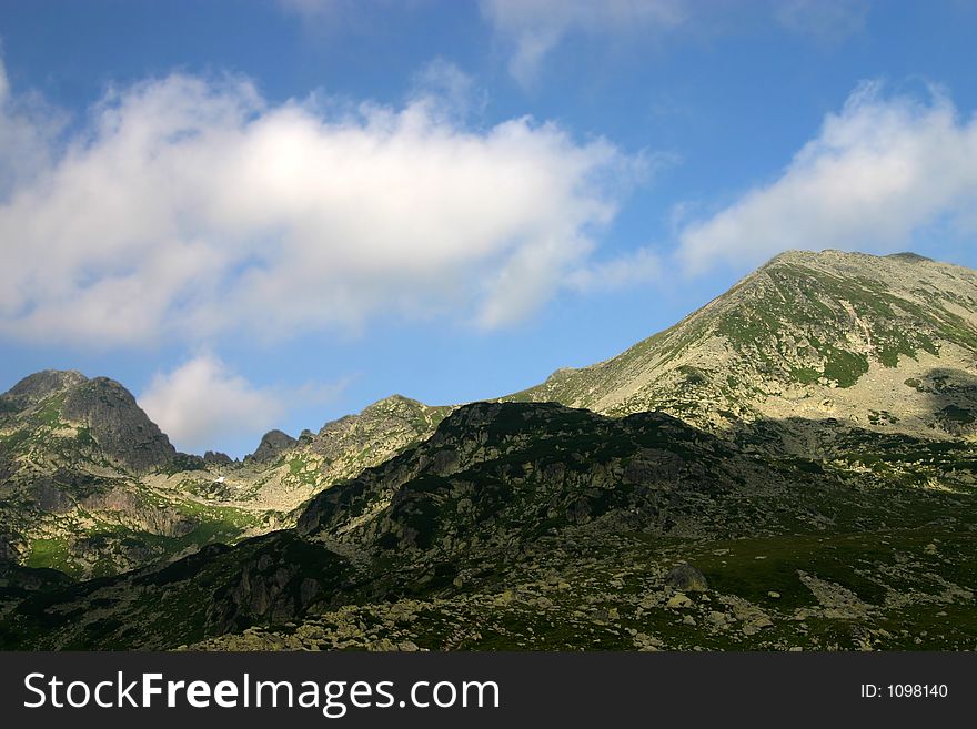 Retezat mountains peaks on summer sky. Retezat mountains peaks on summer sky