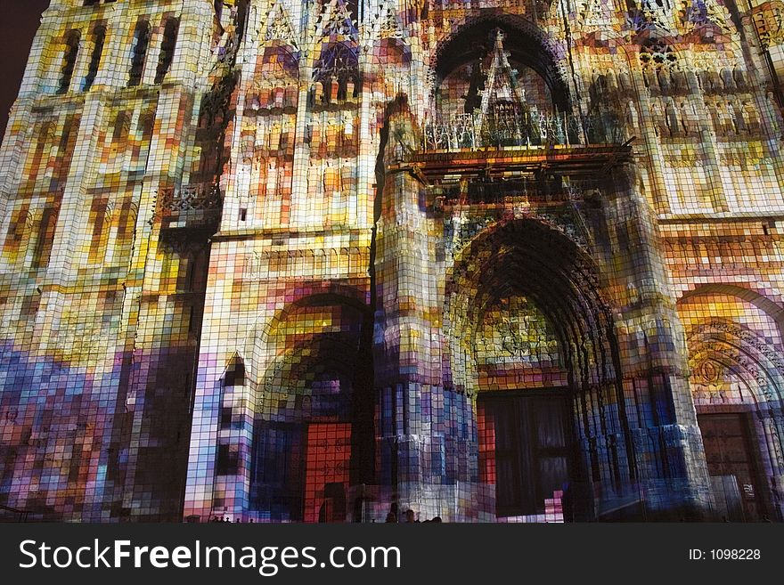 Rouen Cathedral in France lit up by projected pixel patterns and color. Tribute to Monet and his study of this building. Rouen Cathedral in France lit up by projected pixel patterns and color. Tribute to Monet and his study of this building.