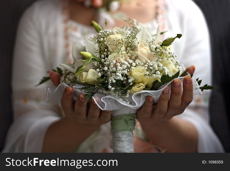 The bride holds a wedding bouquet