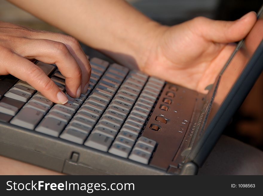 Woman typing on laptop