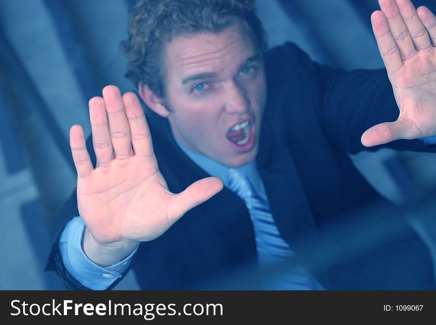 Business man screams and puts up hands in desperation. Business man screams and puts up hands in desperation