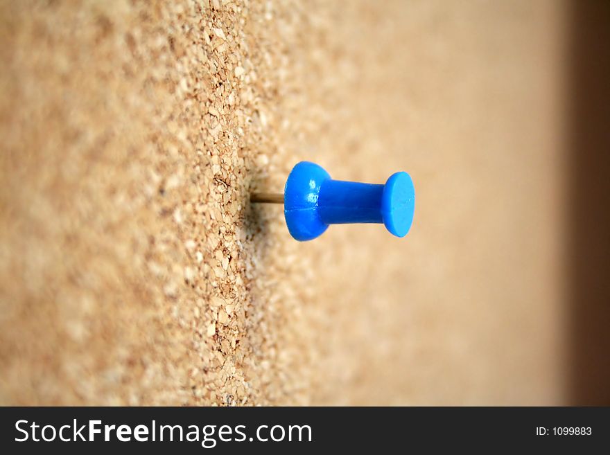 Lonely thumb tack in a cork board. Lonely thumb tack in a cork board