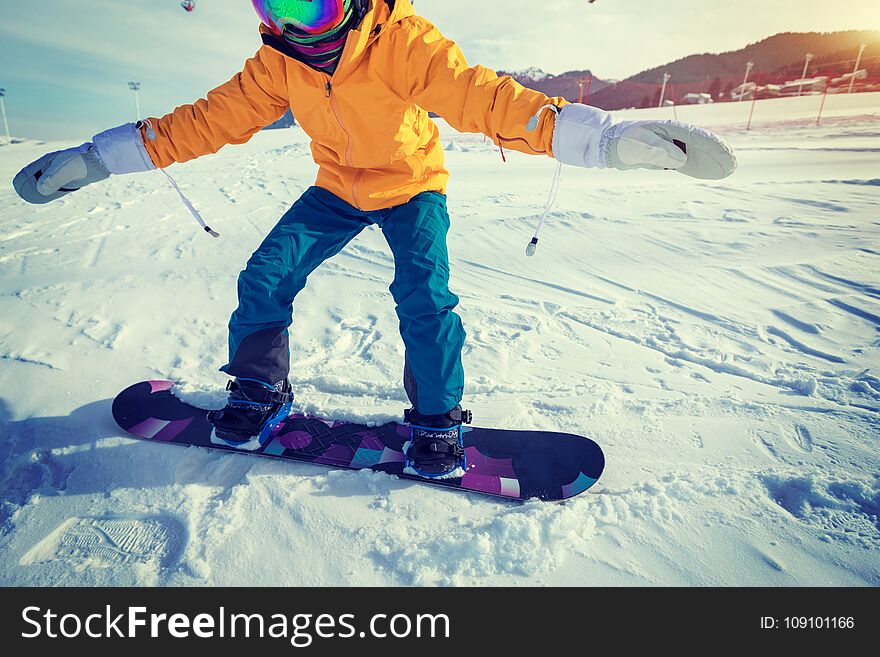 woman snowboarding in winter mountains