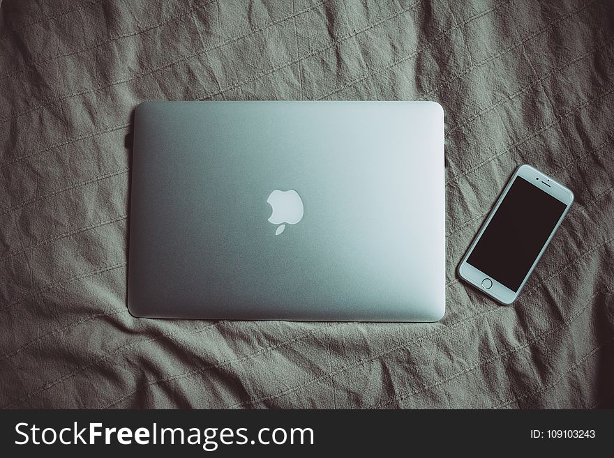 Silver Macbook Beside Silver Iphone 6