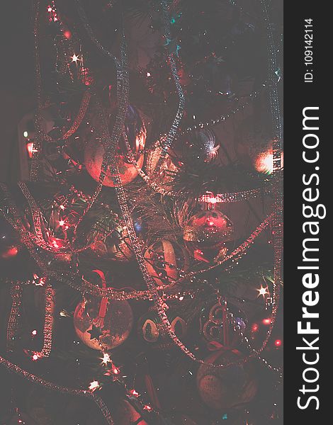 Decorated Christmas tree and colorful garland lights, filtered. Decorated Christmas tree and colorful garland lights, filtered.