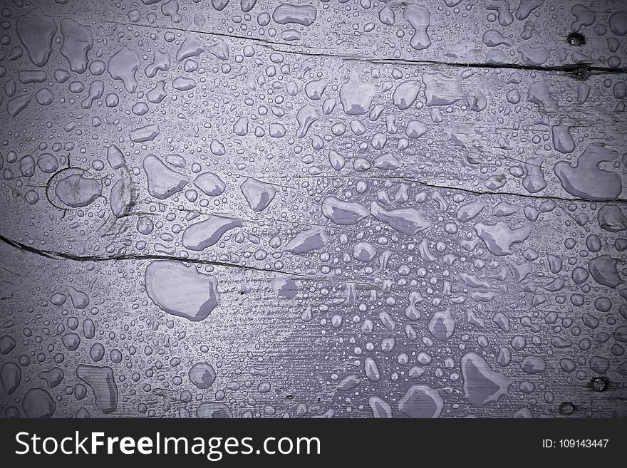 Wooden surface of violet color covered with water drops filtered background. Wooden surface of violet color covered with water drops filtered background.