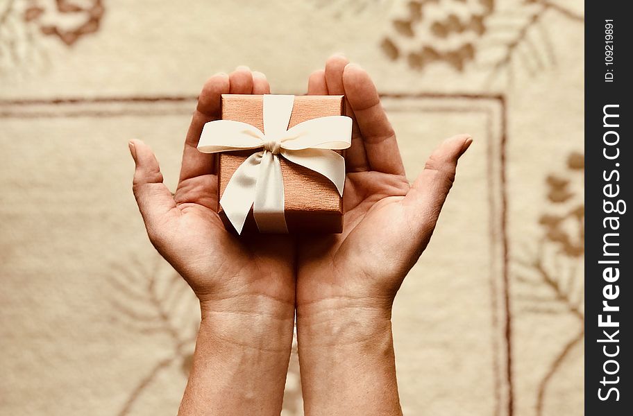 Person&#x27;s Holds Brown Gift Box