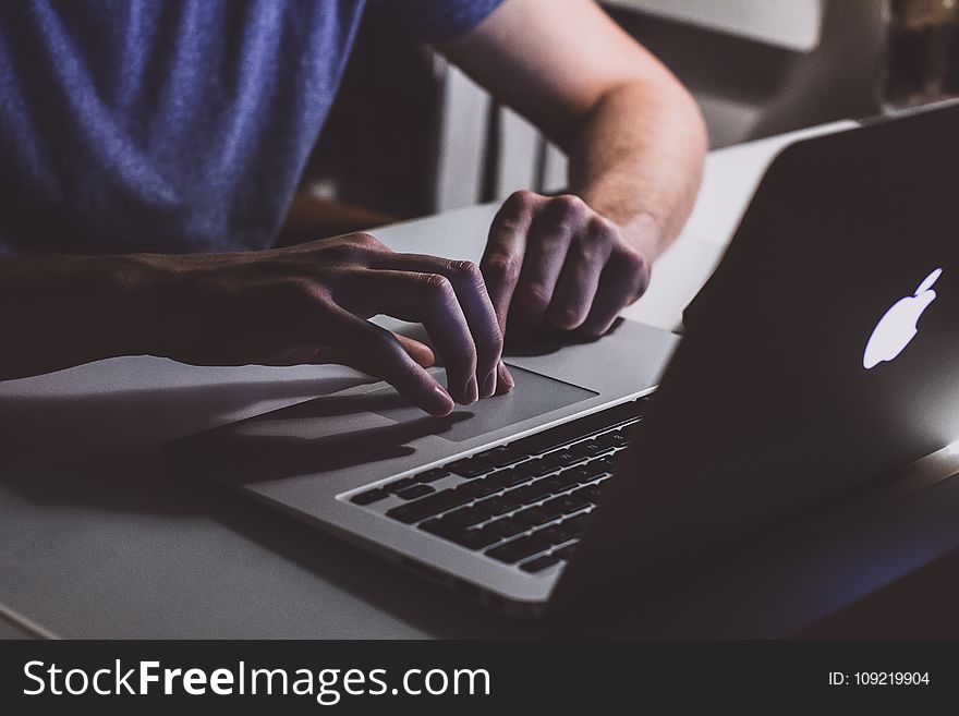 Person Touching Open Macbook On Table