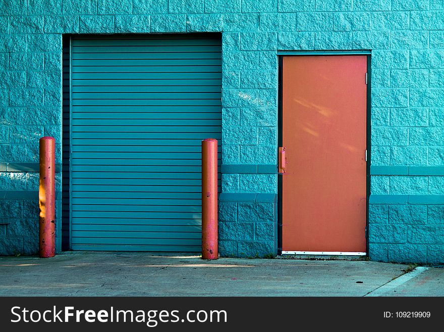 Brown Panel Door Near Roll-up Gate