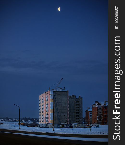 The moon in the cloudy sky over the night city. The moon in the cloudy sky over the night city