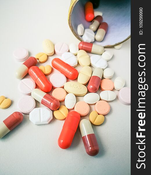 Medication white and colorful tablets arranged abstract on white color background. capsule pills for design. Health, treatment, choice healthy lifestyle concept. Copy space for advertisement. Medication white and colorful tablets arranged abstract on white color background. capsule pills for design. Health, treatment, choice healthy lifestyle concept. Copy space for advertisement.