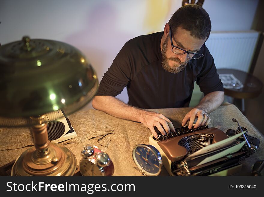 Author working at the office with typewriter