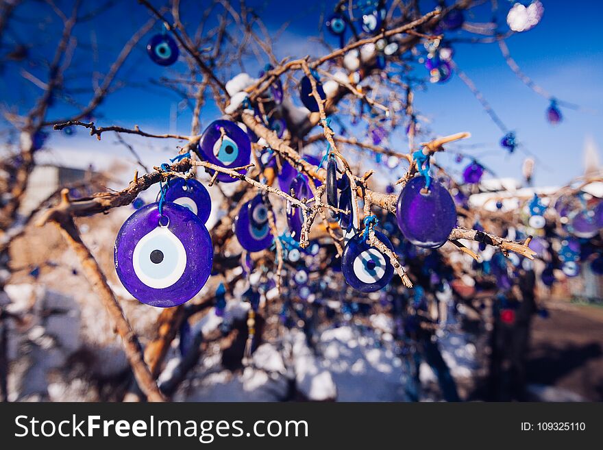 Nazar, charms to ward off the evil eye , on the branches of a tree in Cappadocia, Turkey