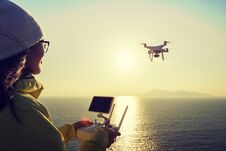 Remote Control A Flying Drone Which Taking Photo Over Sunrise Sea Stock Photo
