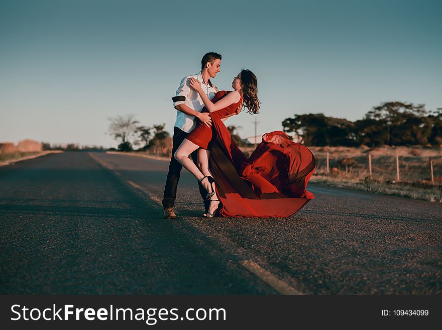 Man and Woman Doing Dance Post in Concrete Road at Daytime