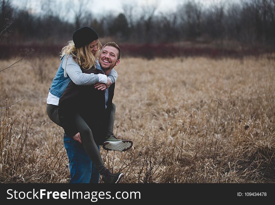 Photo of a Man Carrying His Partner
