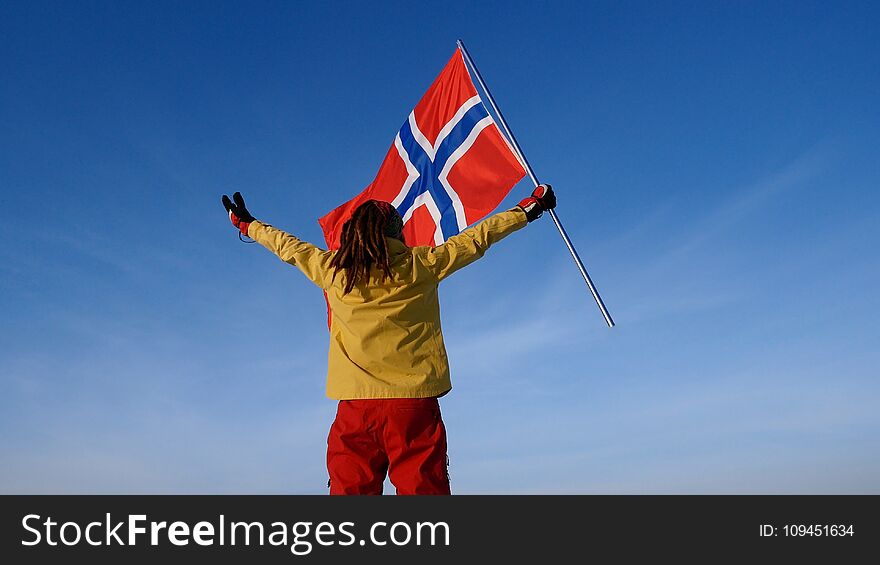Man with norway flag on the top point. Succesful winer consept