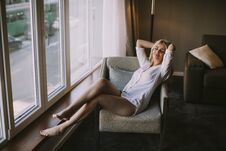 Blond Woman Sitting By Window At Day Light Royalty Free Stock Image
