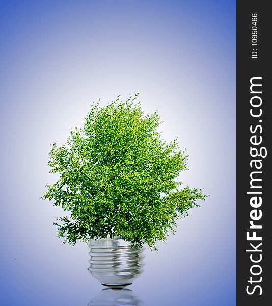 Tree in light bulb symbolizing green energy