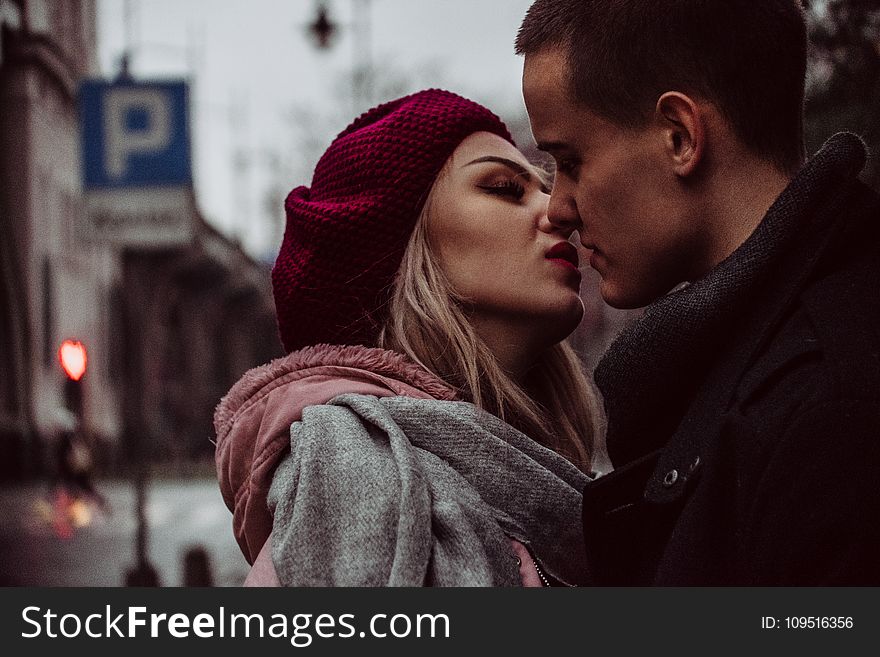 Close Up Photograph of Woman Kissing Man
