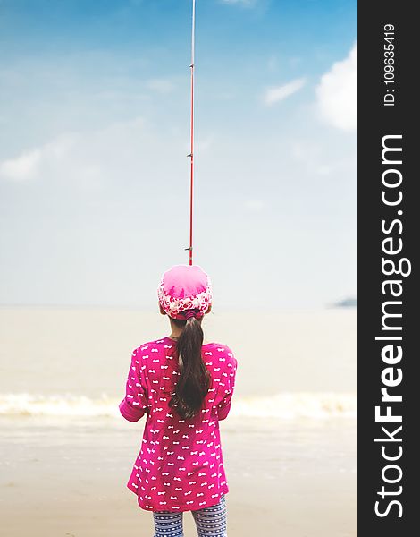 Woman in Pink Long-sleeved Shirt Holding Red Fishing Rod