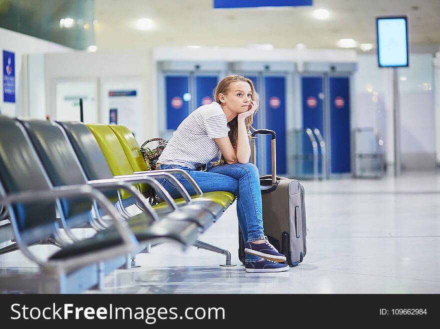 Woman in international airport waiting for her flight
