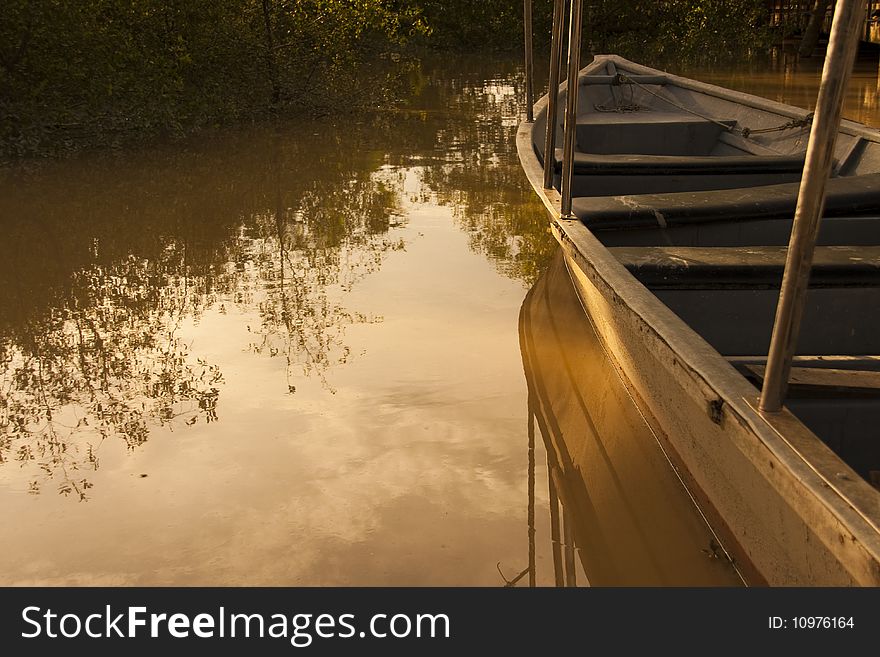 A partial boat view over calm water. A partial boat view over calm water