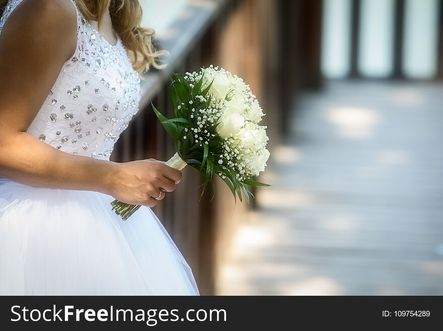 Close view of beautiful colorful wedding bouquet in a hand of a