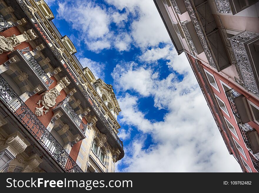 Architecture of Lourdes, France. Beautiful old houses on one of the streets and sky. Details