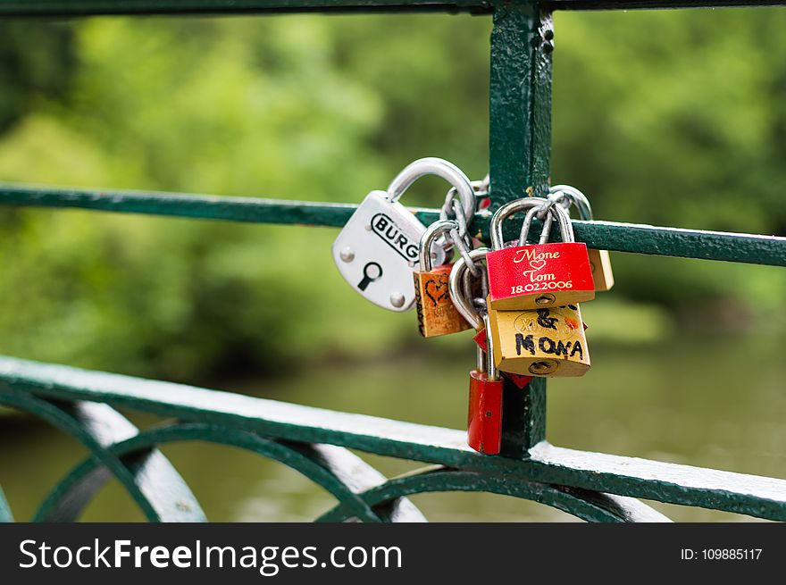 Silver Brown and Red Padlock on Green Steel Trail