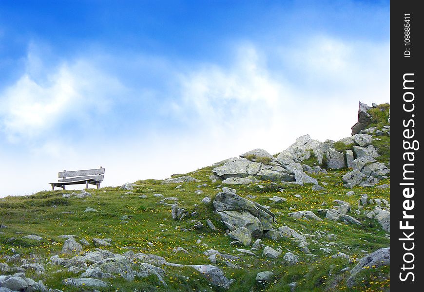 White Wooden Bench in Mountain during Daytime