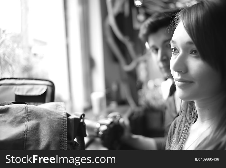 Grayscale Photo Of A Woman Being Stared By A Man Inside A Room