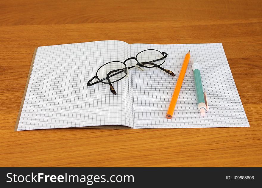 Black Framed Eyeglass On Graphing Paper