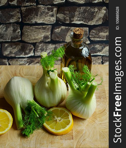 White Onion With Sliced Lemon on Beige Table