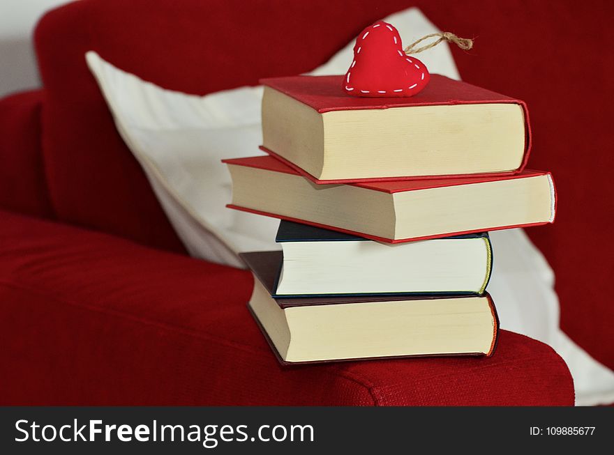 Red Heart Keychain on Top of Stacking of Books
