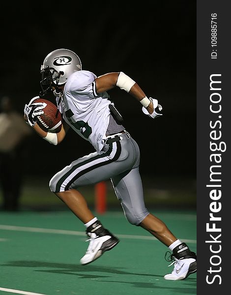 Football Player Holding Football