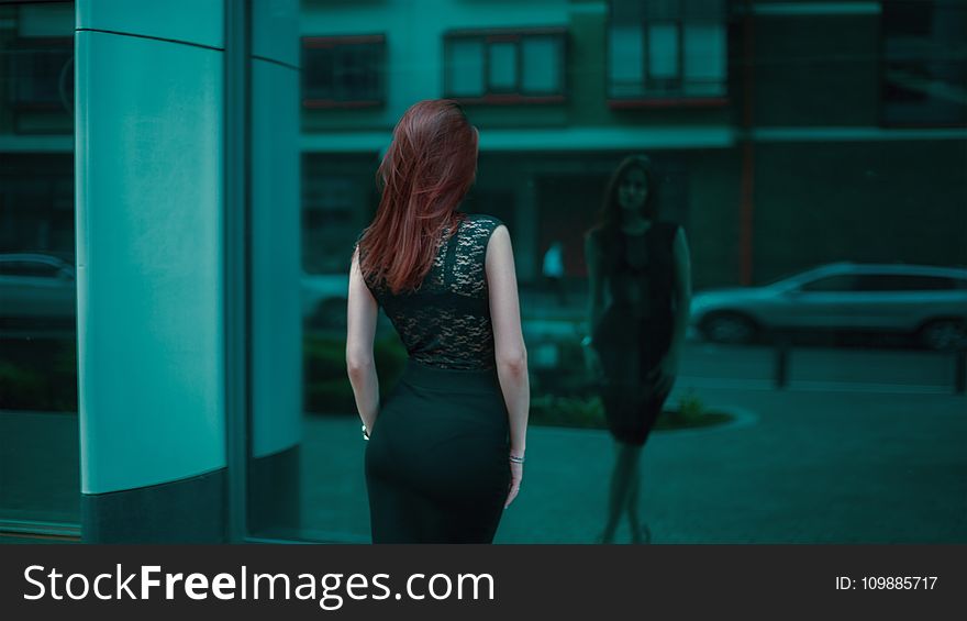 Woman in Black Lace Bodycon Dress in Front of Building Mirror