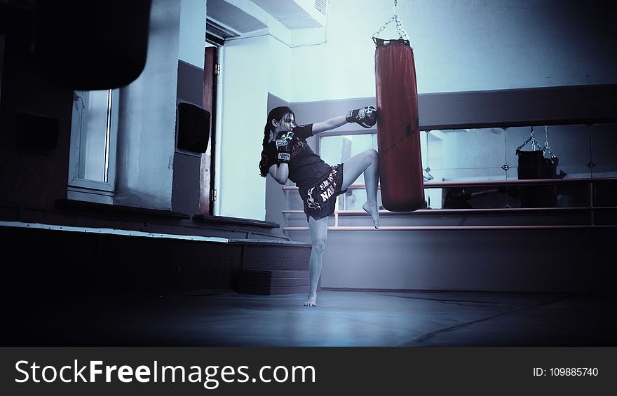 Woman Punching Red Heavy Bag