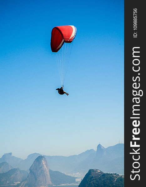 Red White Parachute On Top Of Mountains During Daytime