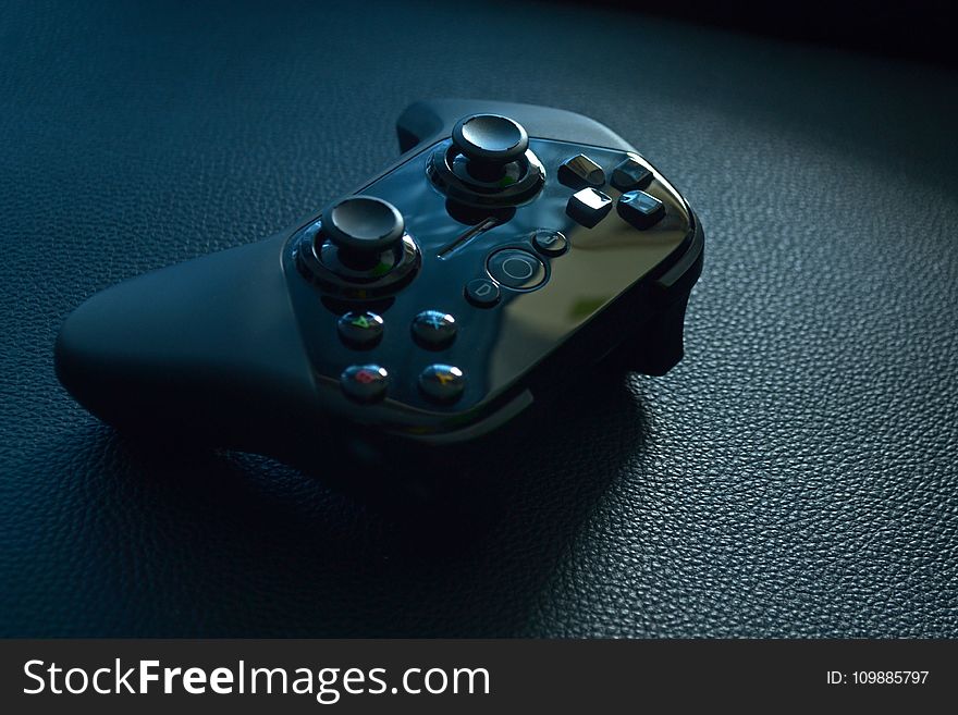 Black Wireless Game Controller on Black Leather