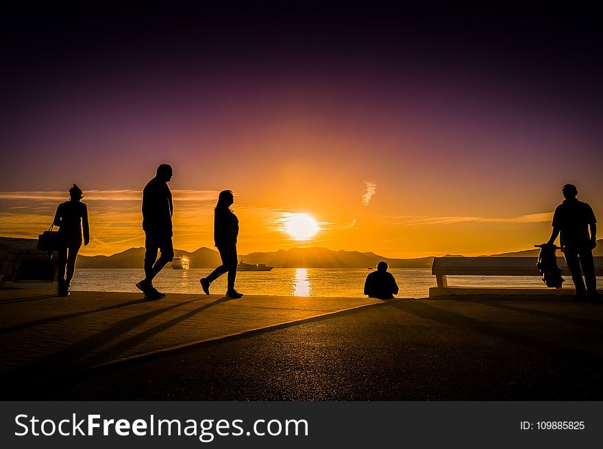 Silhouette Photography of People Near Body of Water